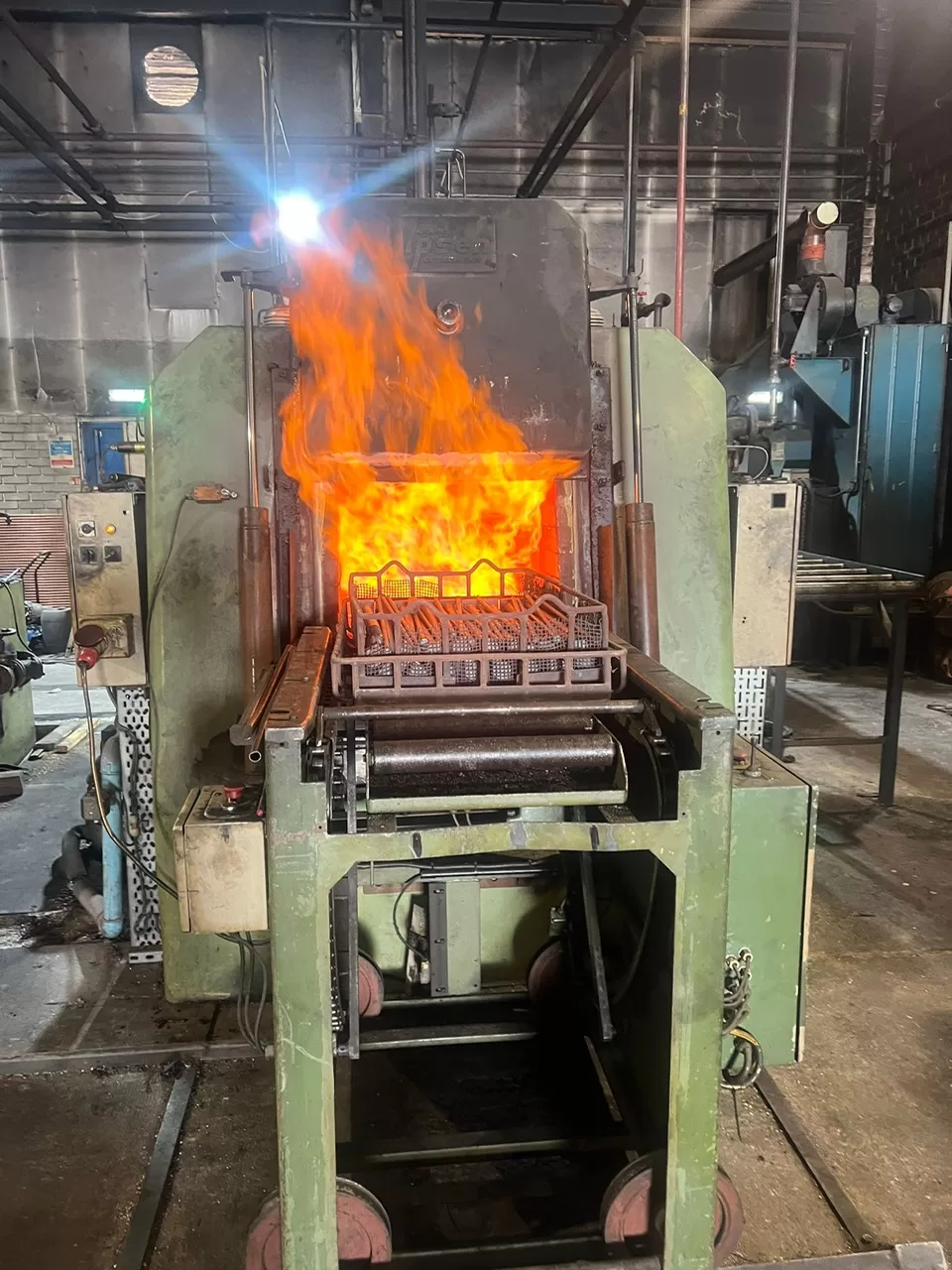 Steel components at heat inside an industrial furnace at Heat Treatment Coventry